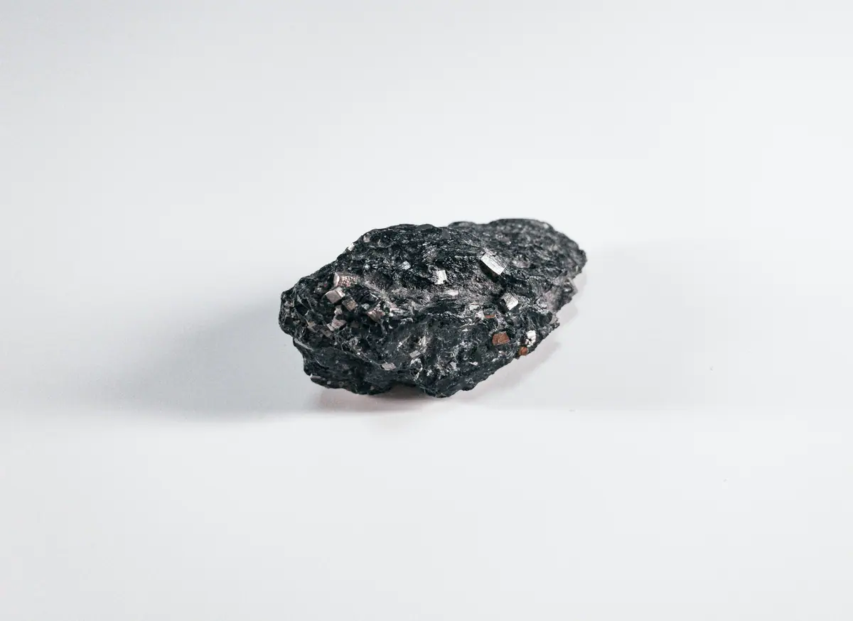 A single lump of coal with a glossy, fractured face