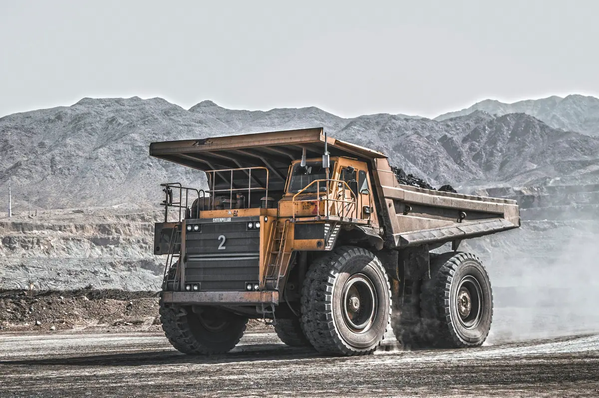 A loaded haul truck on a mine road